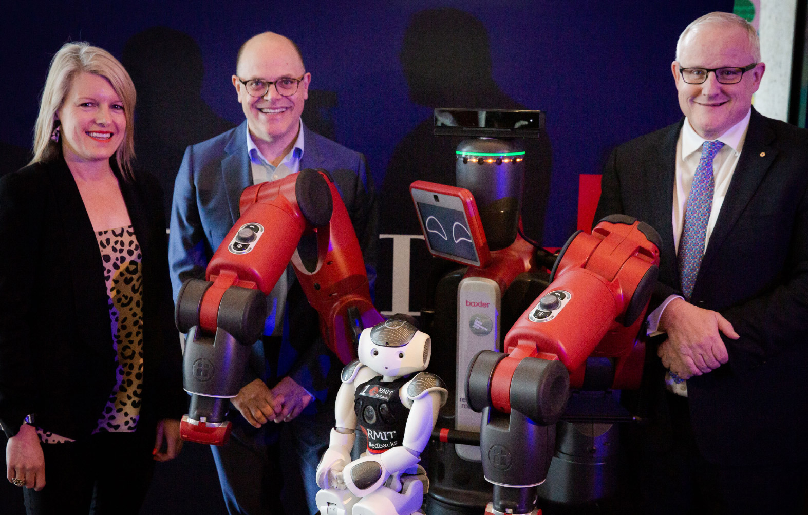 People standing with an RMIT robot